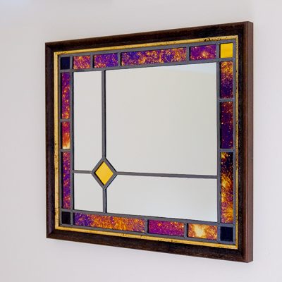 Framed stained glass mirror in purple and gold